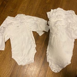 20 white onesies in various sizes.